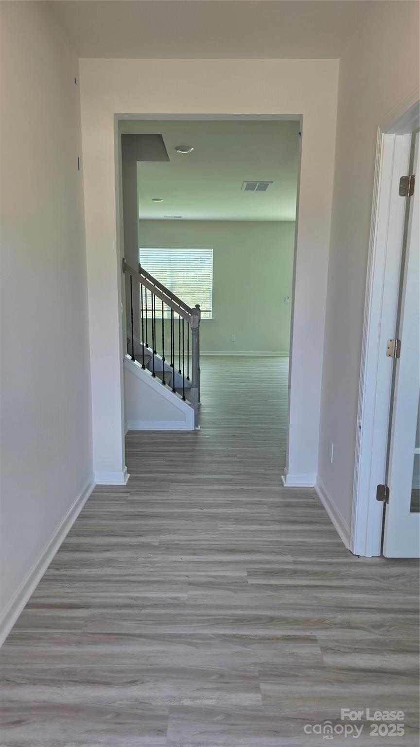 1345 Secrest Cmns Drive Monroe, NC 28112 - Photo 2 of 19 a view of a hallway with wooden floor and staircase