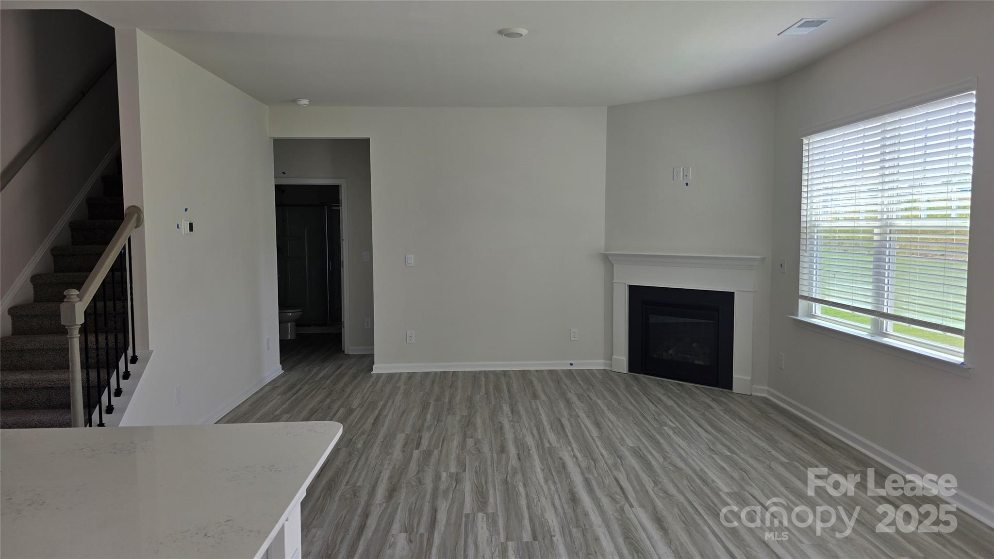 1345 Secrest Cmns Drive Monroe, NC 28112 - Photo 5 of 19 a view of an empty room with wooden floor and a window