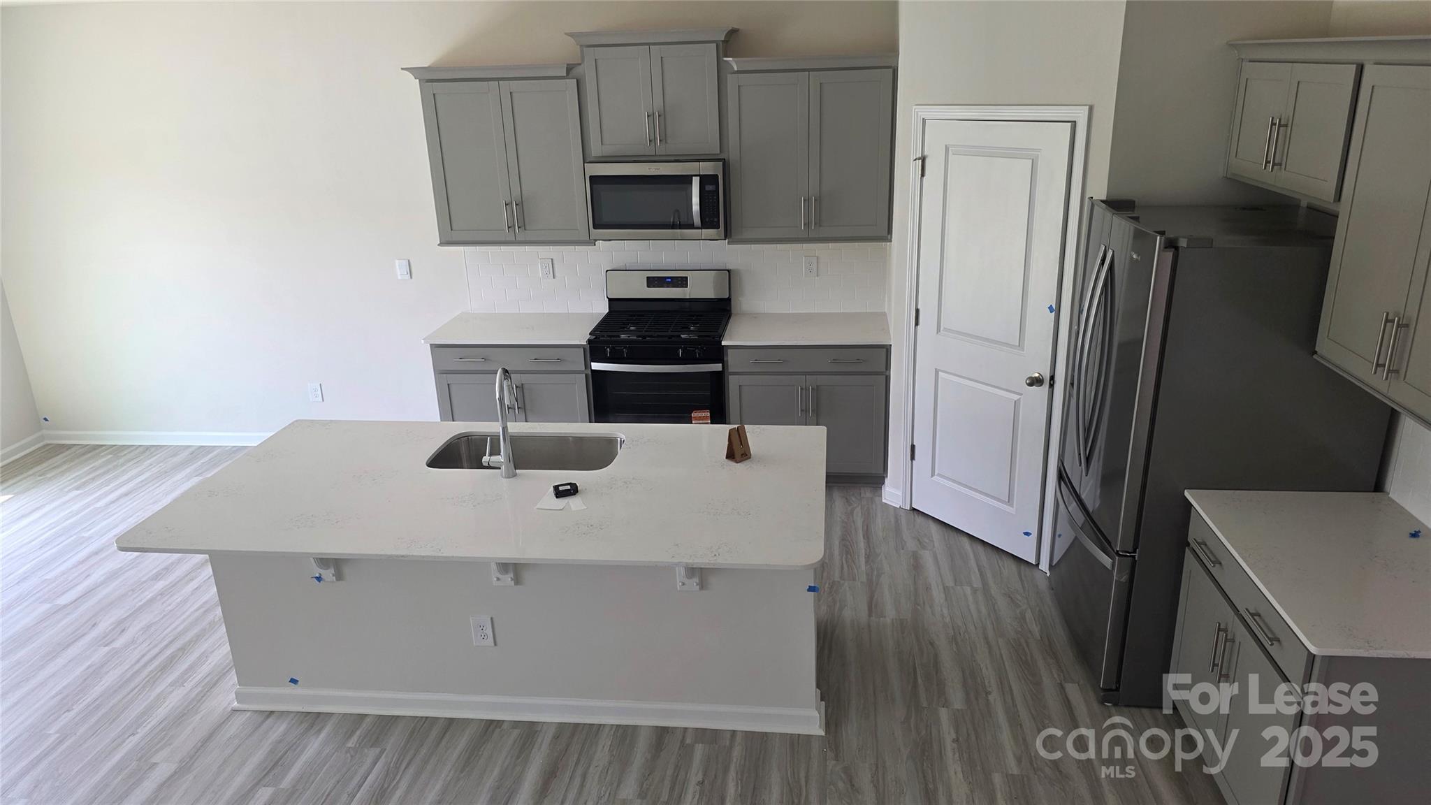 1345 Secrest Cmns Drive Monroe, NC 28112 - Photo 6 of 19 a kitchen with a sink a microwave a refrigerator and cabinets