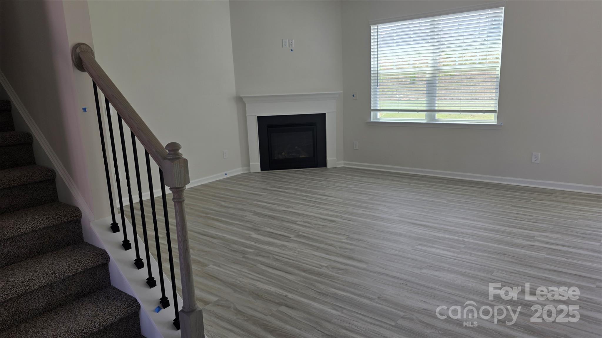 1345 Secrest Cmns Drive Monroe, NC 28112 - Photo 9 of 19 a view of an empty room with wooden floor and a window