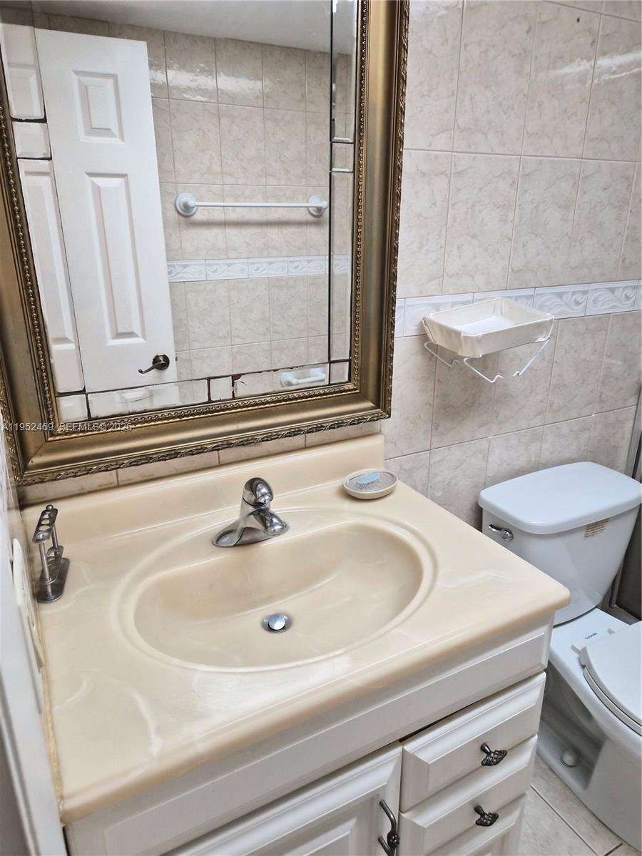 1101 Northwest 58th Terrace, Unit 202 Sunrise, FL 33313 - Photo 11 of 12 a bathroom with a sink and a toilet