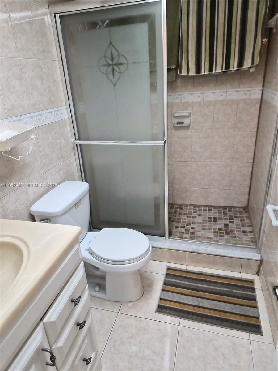 1101 Northwest 58th Terrace, Unit 202 Sunrise, FL 33313 - Photo 12 of 12 a bathroom with a toilet and a shower