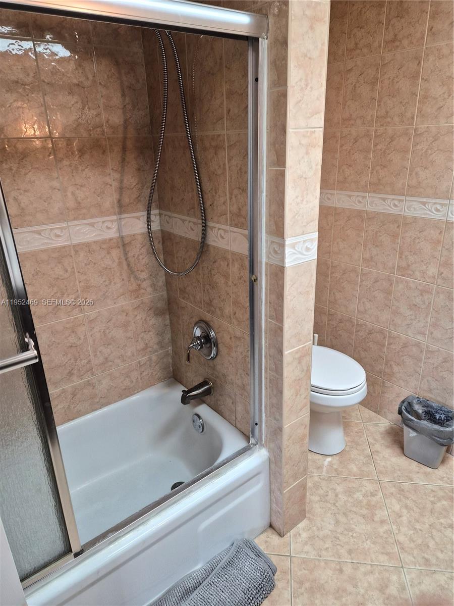 1101 Northwest 58th Terrace, Unit 202 Sunrise, FL 33313 - Photo 2 of 12 a bathroom with a tub and toilet