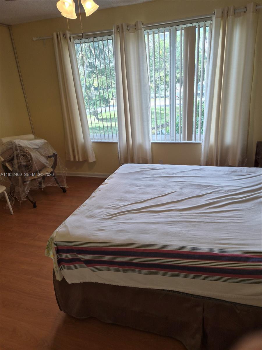 1101 Northwest 58th Terrace, Unit 202 Sunrise, FL 33313 - Photo 3 of 12 a bedroom with a bed and a window
