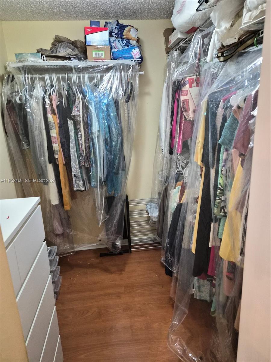 1101 Northwest 58th Terrace, Unit 202 Sunrise, FL 33313 - Photo 5 of 12 a view of walk in closet with clothes and shoes