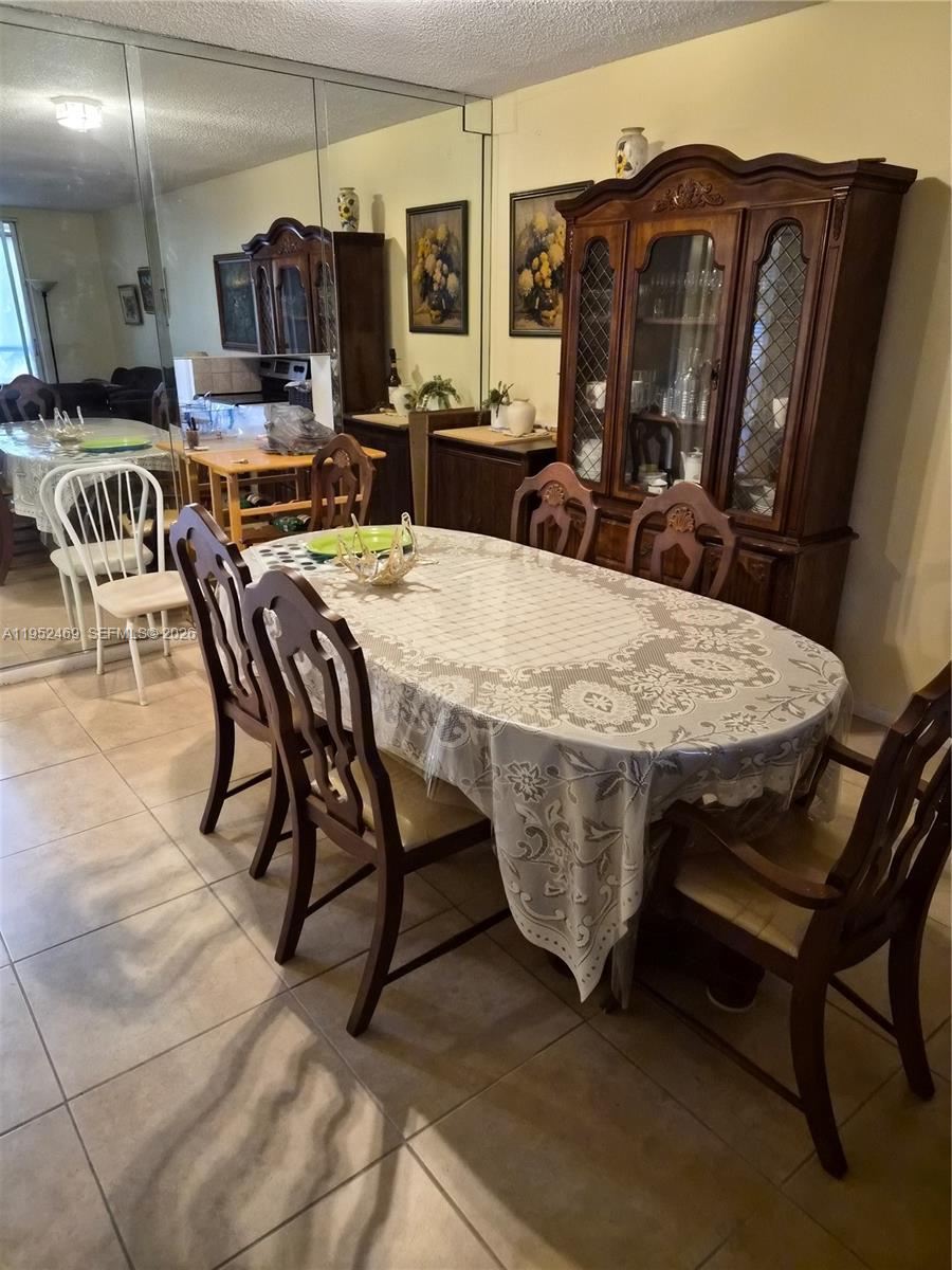 1101 Northwest 58th Terrace, Unit 202 Sunrise, FL 33313 - Photo 8 of 12 a dining table with chairs and wooden floor
