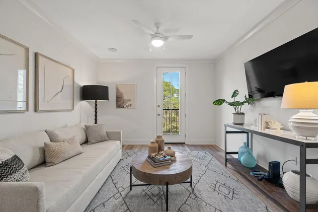 a living room with furniture and a wooden floor