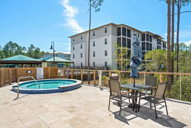 a swimming pool with outdoor seating and plants