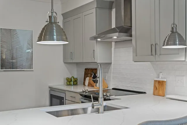 a kitchen with stainless steel appliances granite countertop a sink and a stove