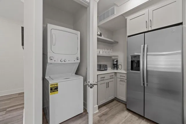 a kitchen with white cabinets and white appliances