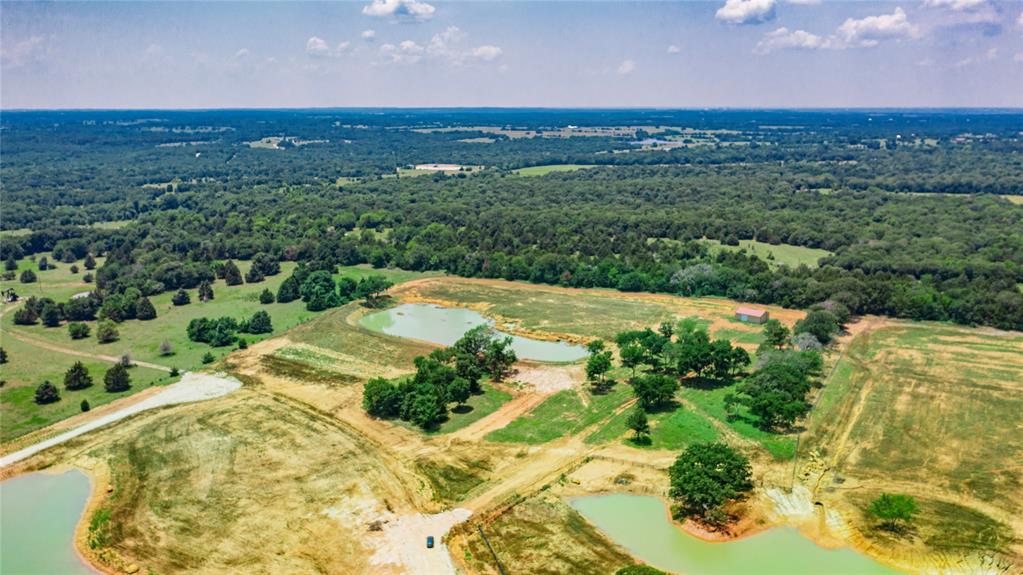 1789 Brumelow Road Whitesboro, TX 76273 - Photo 10 of 30 Expansive property featuring multiple ponds, mature trees, open fields, and distant wooded areas