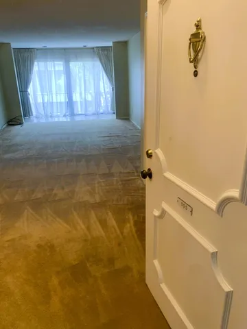 a living room with furniture and a floor to ceiling window