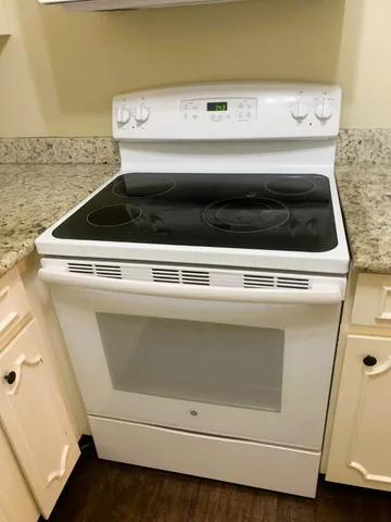 a bathroom with a granite countertop sink and vanity