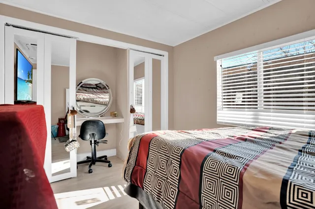 a bedroom with a bed and a window