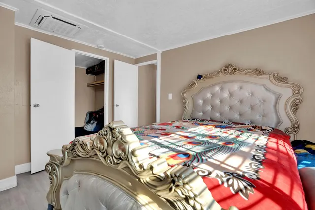 a bedroom with a bed and a mirror