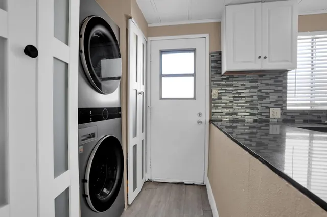 a view of a hallway with washer and dryer