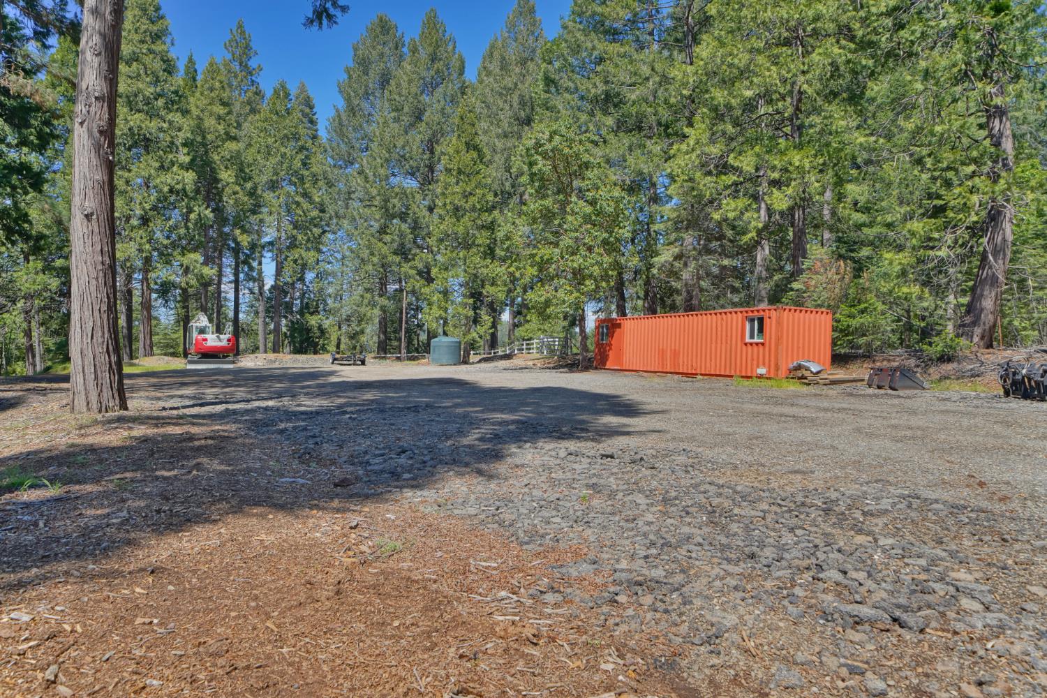 2320 Old Blair Mill Road Pollock Pines, CA 95726 - Photo 39 of 45 Large flat area with cargo container. This area has (separate from house) well, water tank, power and septic!