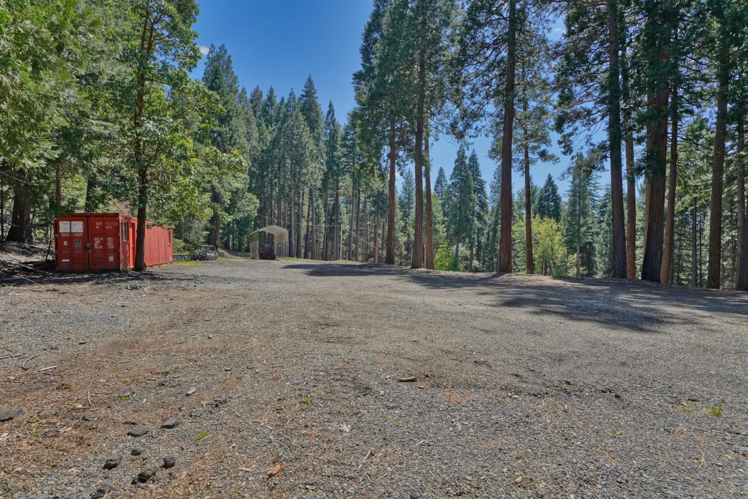 2320 Old Blair Mill Road Pollock Pines, CA 95726 - Photo 41 of 45 Large flat area with cargo container. This area has (separate from house) well, water tank, power and septic!