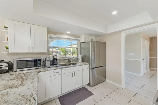 a bedroom with a bed and a flat tv screen on dresser