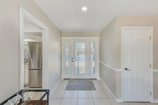 a kitchen with stainless steel appliances kitchen island granite countertop a table chairs and a refrigerator