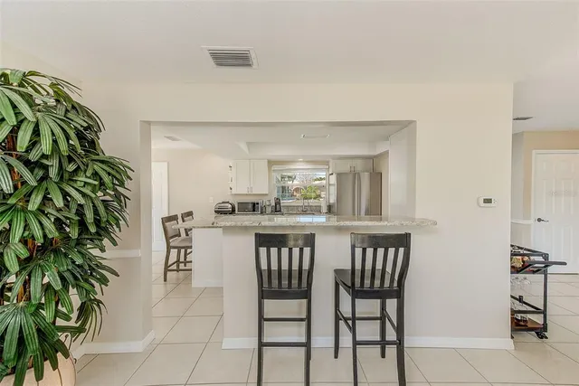 a view of a dining room with a table and chairs