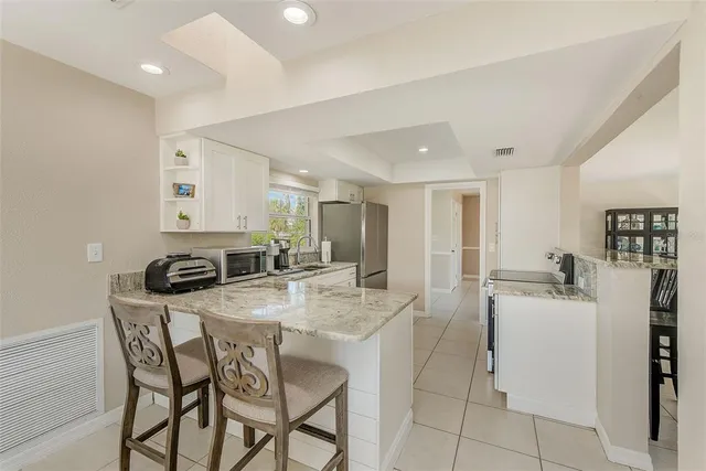 a view of a dining room with furniture a chandelier and wooden floor