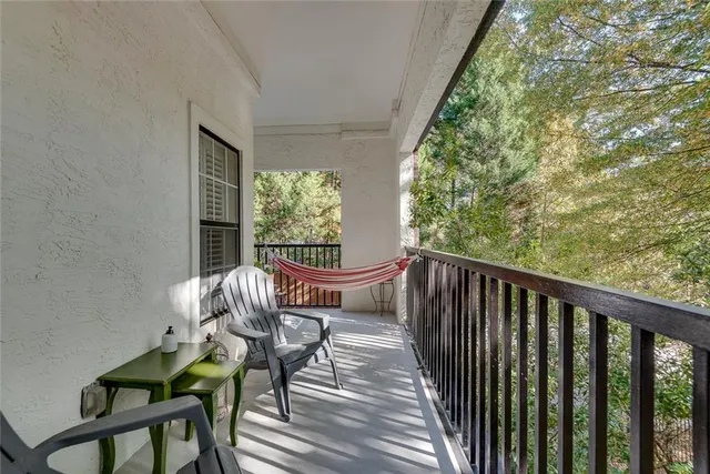 a view of a balcony with chair and potted plants