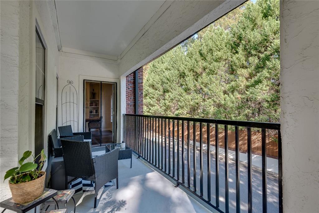 3275 Lenox Road Northeast, Unit 108 Atlanta, GA 30324 - Photo 14 of 22 a view of a balcony with chair and potted plants