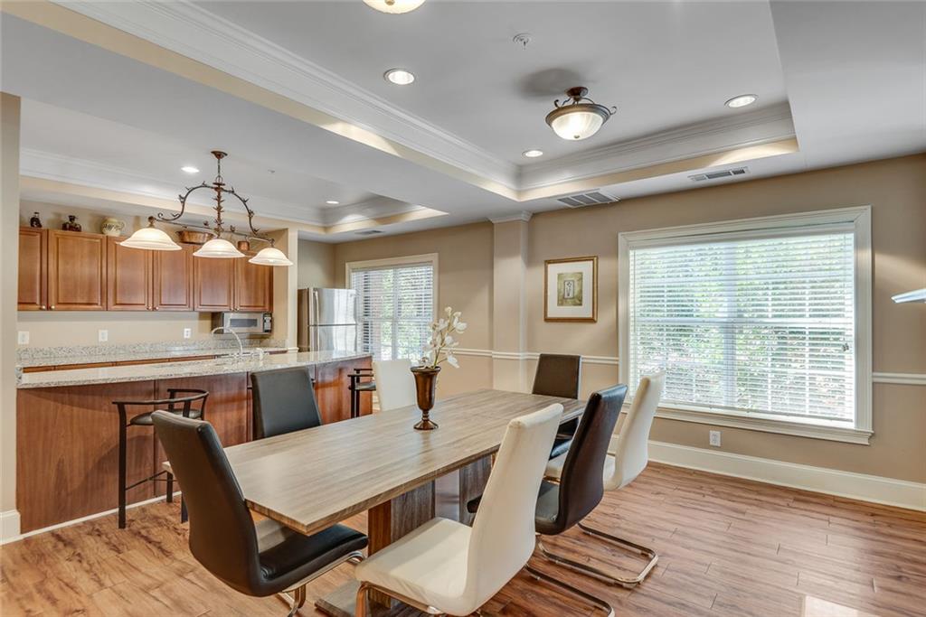 3275 Lenox Road Northeast, Unit 108 Atlanta, GA 30324 - Photo 17 of 22 a view of a dining room with furniture window and wooden floor