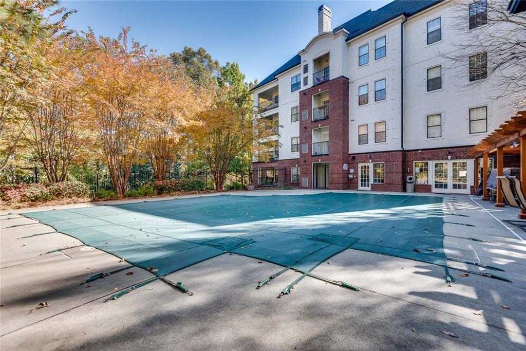 3275 Lenox Road Northeast, Unit 108 Atlanta, GA 30324 - Photo 20 of 22 a view of a building with a yard