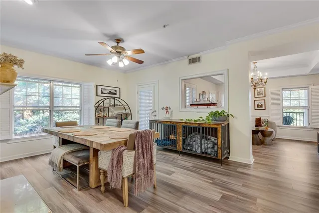 a view of a dining room with furniture window and wooden floor