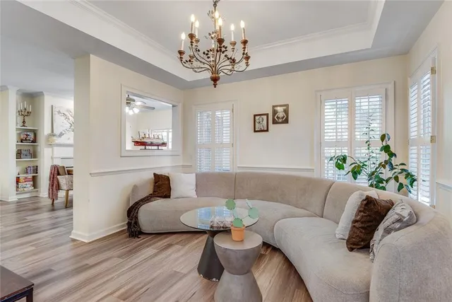 a bedroom with a large bed and a chandelier