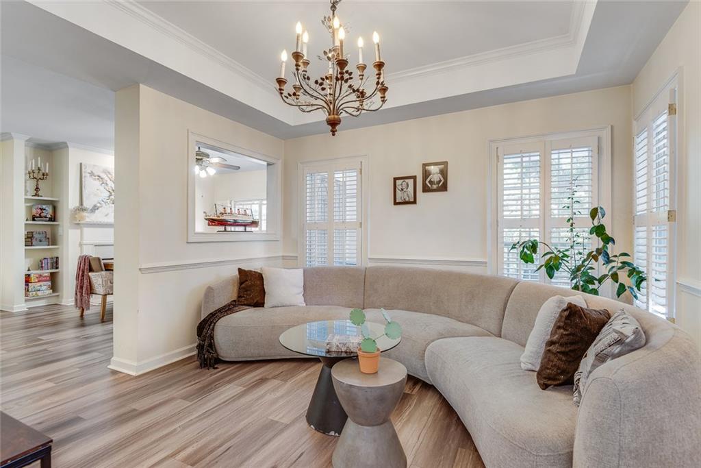 3275 Lenox Road Northeast, Unit 108 Atlanta, GA 30324 - Photo 7 of 22 a living room with furniture and a chandelier