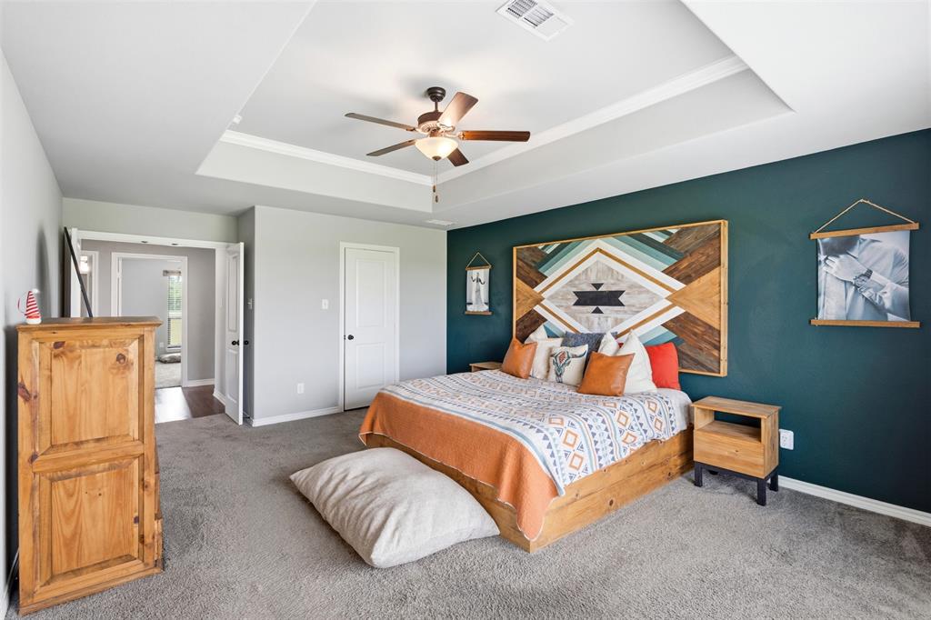 2990 Wilson Road Palmer, TX 75152 - Photo 31 of 40 a bedroom with a bed and a chandelier