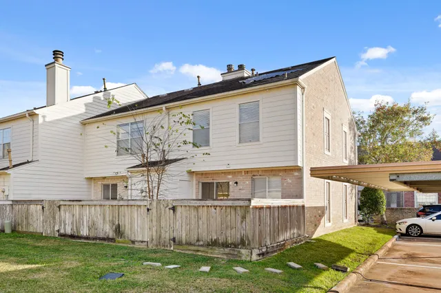 a view of a house with a yard and sitting area