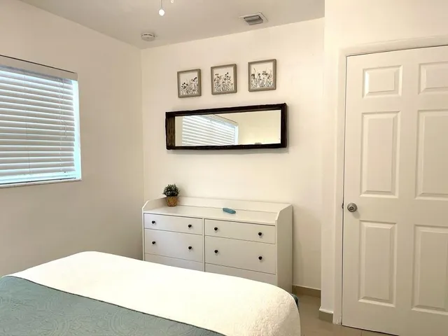 a living room with a bed furniture and a large window