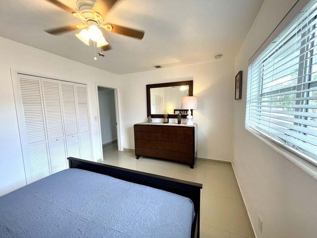 29 Northeast 3rd Street Dania Beach, FL 33004 - Photo 21 of 31 a living room with a bed furniture and a large window