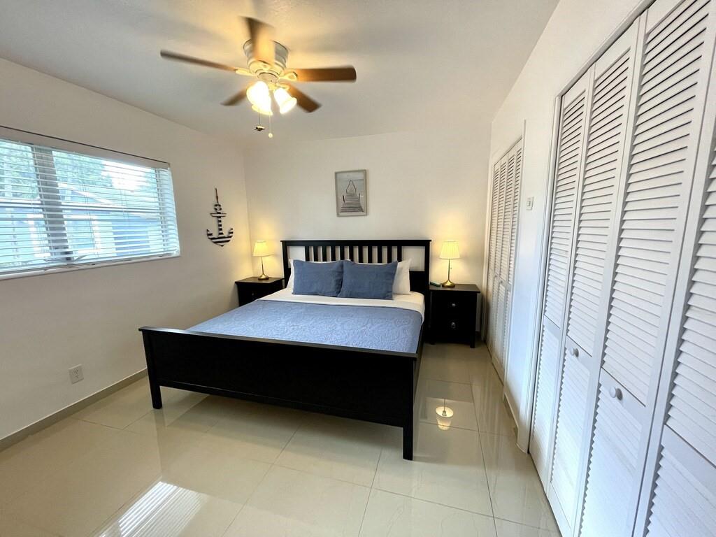 29 Northeast 3rd Street Dania Beach, FL 33004 - Photo 22 of 31 a bedroom with a bed and a chandelier