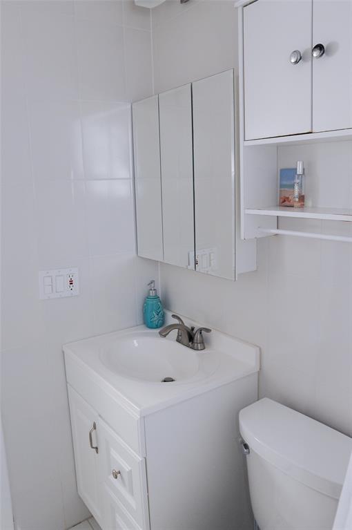 29 Northeast 3rd Street Dania Beach, FL 33004 - Photo 26 of 31 a bathroom with a sink a toilet and vanity