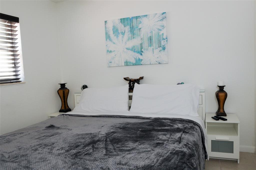 29 Northeast 3rd Street Dania Beach, FL 33004 - Photo 28 of 31 a bedroom with bed and painting on the wall