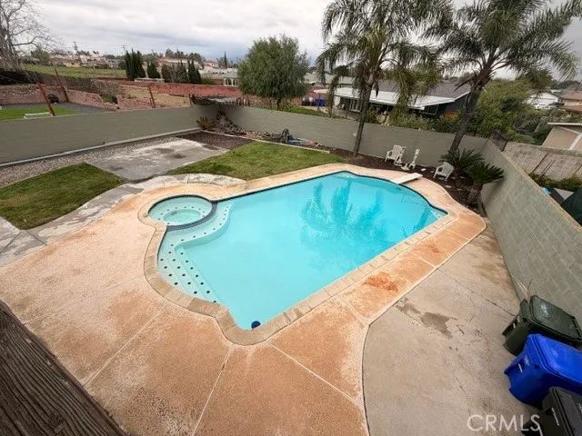 a view of a swimming pool with a yard
