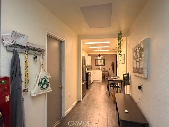 a view of a hallway that has a dining table and chairs