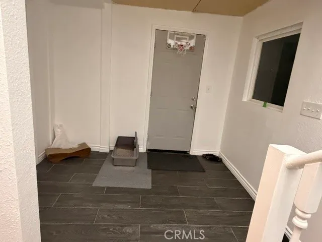 a view of an empty room and wooden floor