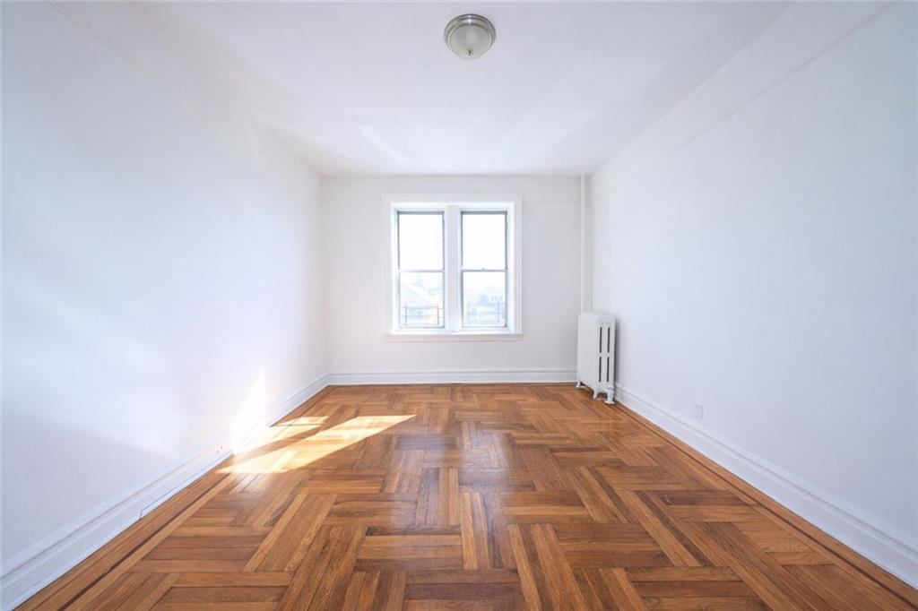 1489 East 8th Street, Unit C2 Brooklyn, NY 11230 - Photo 11 of 15 a view of an empty room and window