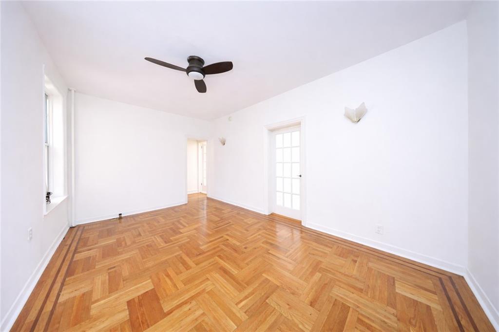 1489 East 8th Street, Unit C2 Brooklyn, NY 11230 - Photo 12 of 15 a view of a big room with wooden floor and windows