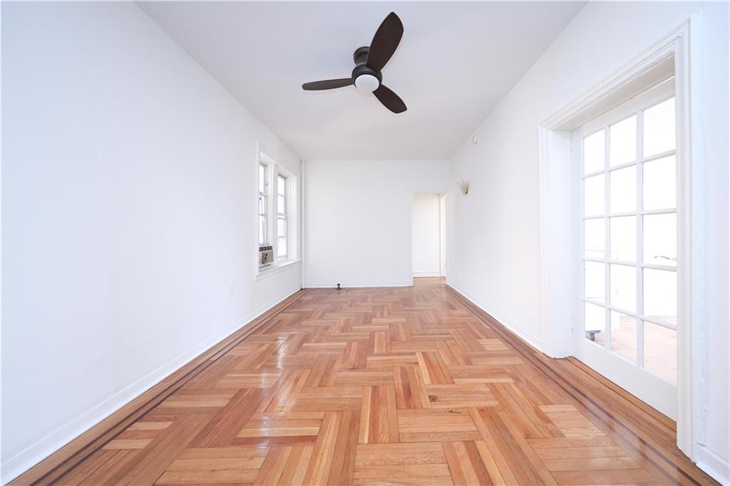 1489 East 8th Street, Unit C2 Brooklyn, NY 11230 - Photo 4 of 15 a view of empty room with wooden floor and fan
