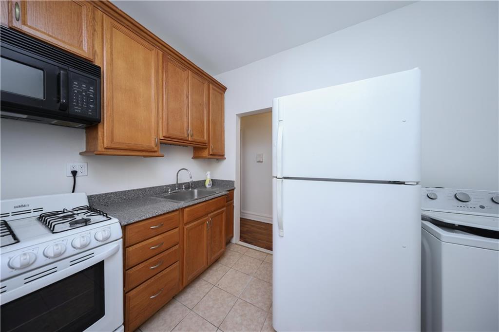 1489 East 8th Street, Unit C2 Brooklyn, NY 11230 - Photo 8 of 15 a kitchen with a refrigerator sink and stove top oven