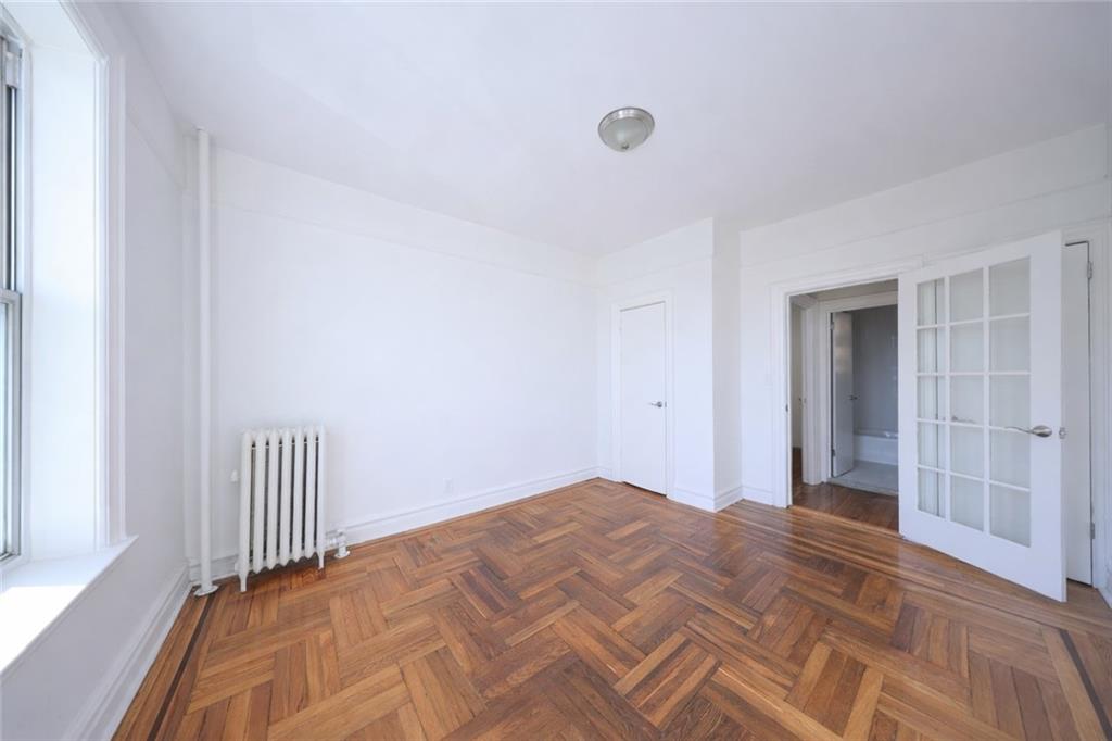 1489 East 8th Street, Unit C2 Brooklyn, NY 11230 - Photo 10 of 15 a view of a room with wooden floor and stairs