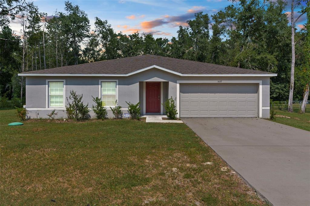 5637 East Tangelo Lane Inverness, FL 34453 - Photo 1 of 23 a front view of house with yard and green space