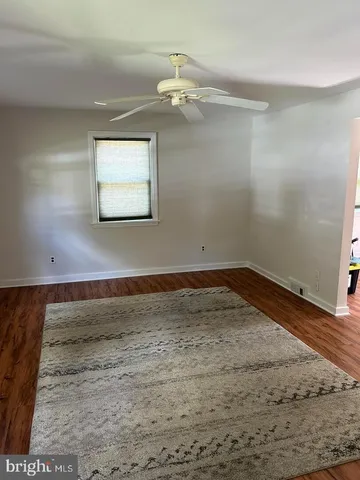 a view of a room with wooden floor